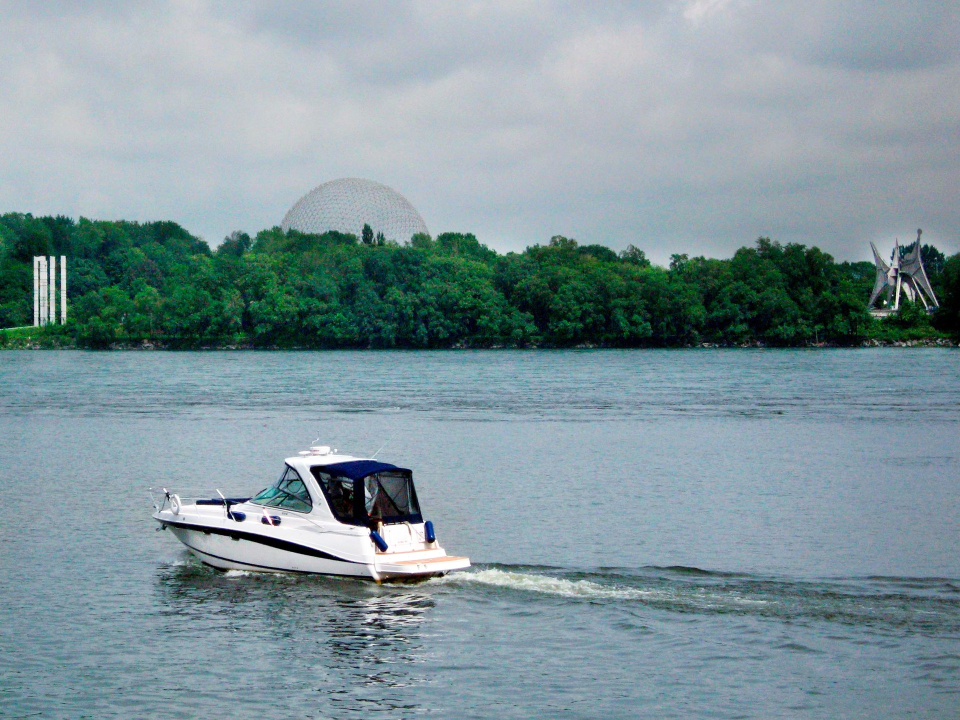The Biosphere in Saint Helene Island. Motorboat in the foreground, St Lawrence river, Montreal, Canada.